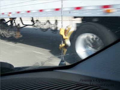 Der Wienerschnitzel antenna topper appearing scared as semi truck is being passed on the freeway