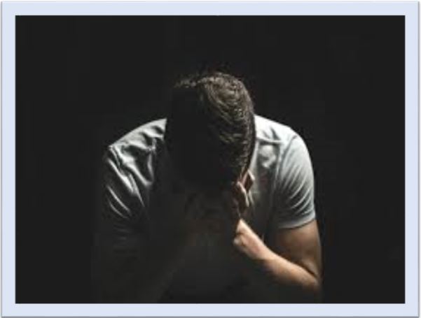 a guy hiding his face in despair being fed up with life