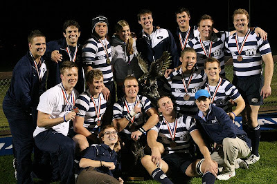 BYU Rugby players and staff come together for a trophy shot