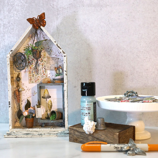 ASW | Tim Holtz Shrine: Shabby Chic Potting Shed Miniature with Speckled Egg and Field Notes details.