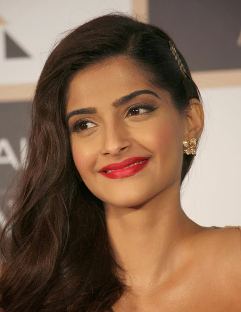 Sonam Kapoor looking radiant in a hot pink outfit, exuding confidence.