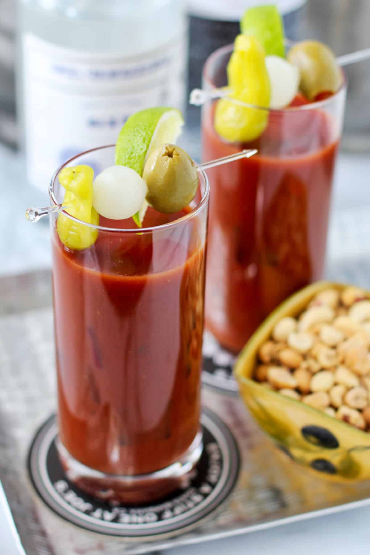 Two bloody Marys in tall glasses.