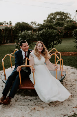 bride and groom playing on playground at the acre orlando