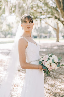 bride in white gown holding bouquet