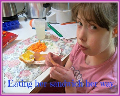 Supergirl Enjoys eating the birthday lunch sandwich her own way.
