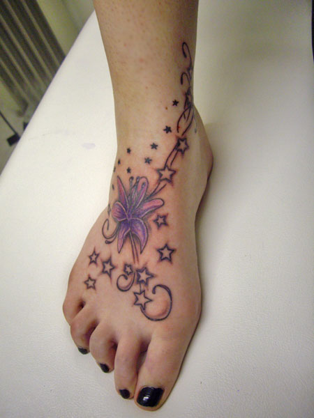 pretty flower tattoos on foot. Feminine stars and lily floral custom artwork tattoo on foot