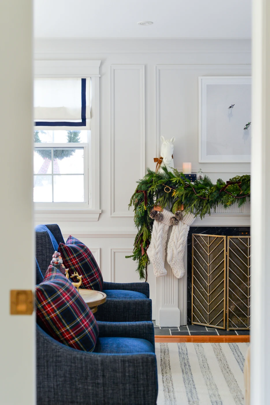 living room christmas decor with plaid pillows, velvet bows, and faux garlands