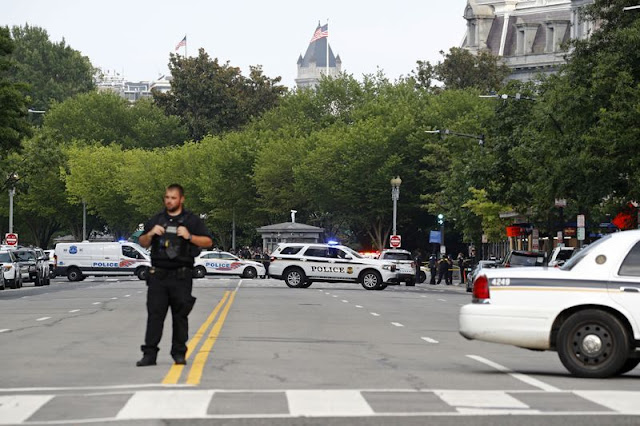 Law enforcement officials gather following a shooting that took place at 17th Street and Pennsylvania Avenue near the White House