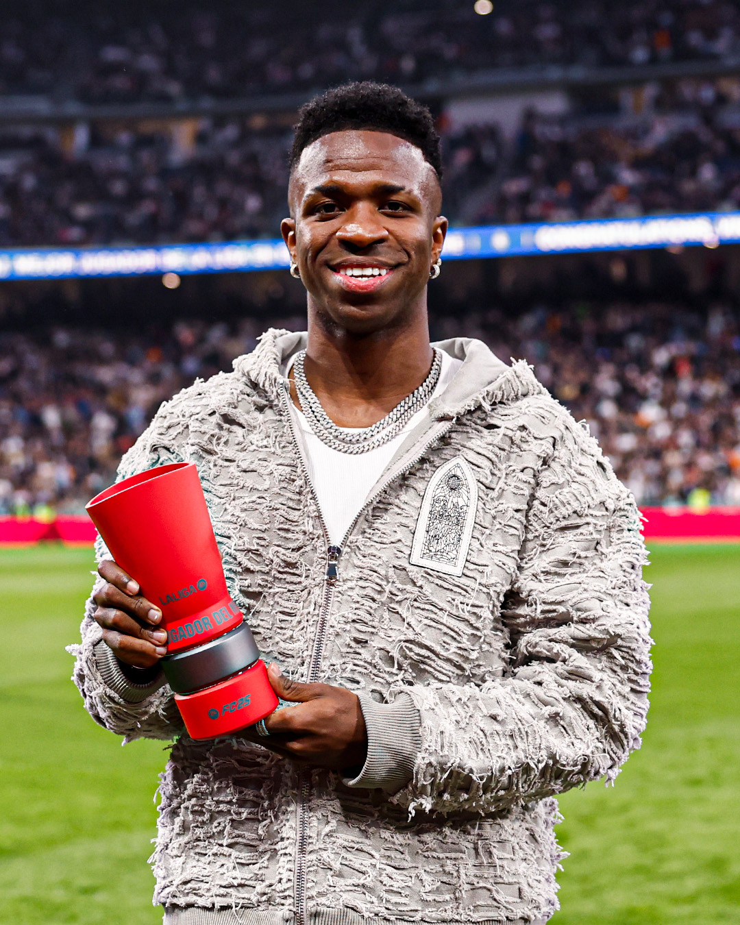 Real Madrid forward, Vinicius Junior, takes a shot with his La Liga Player Of The Month award for November