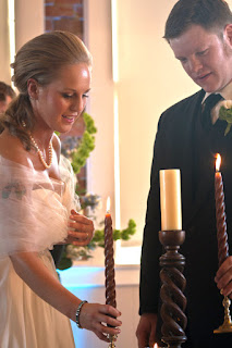 Nicole and Ken kight a unity candle at the Hollywood Schoolhouse