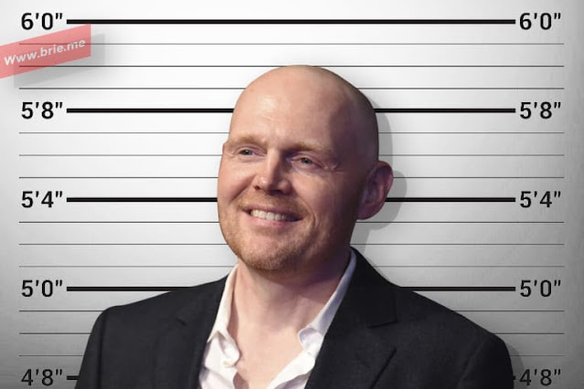 Bill Burr standing in front of a height chart