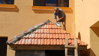 Sally, with sleeves rolled up, fits the ridge tiles