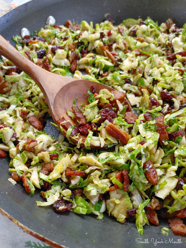 Craisin Bacon Shredded Brussels Sprouts! Thinly sliced brussels sprouts sautéed with crispy bacon, toasted crunchy pecans and sweet, tangy dried cranberries makes a perfect side dish recipe for Thanksgiving or Christmas dinner!