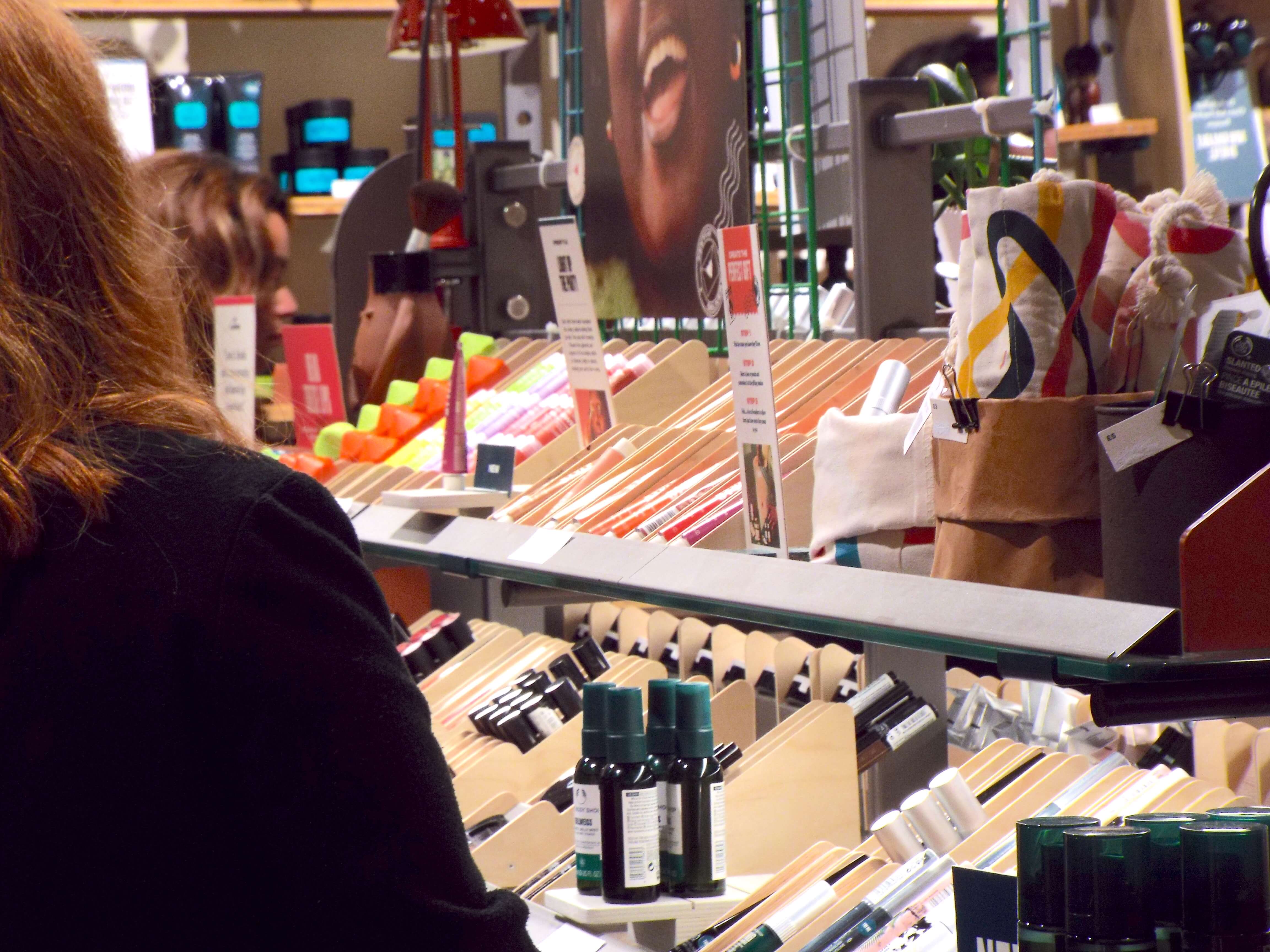 The array of makeup at the makeup counter, with the brightly coloured neon Swipe It Up Lip Balms peeping through in the foreground.