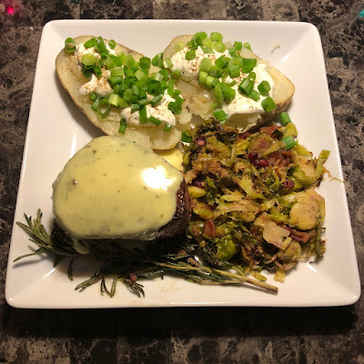 Rare grilled filet mignon, topped with Béarnaise sauce along with some shaved Brussels sprouts with bacon, maple and pomegranate and a big baked potato