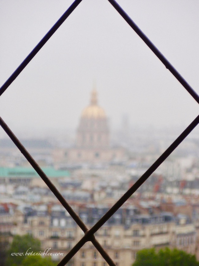 Eiffel Tower gold and silver telescopes offer views of the gold dome of the Invalides Museum below