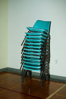 Stack of blue school chairs