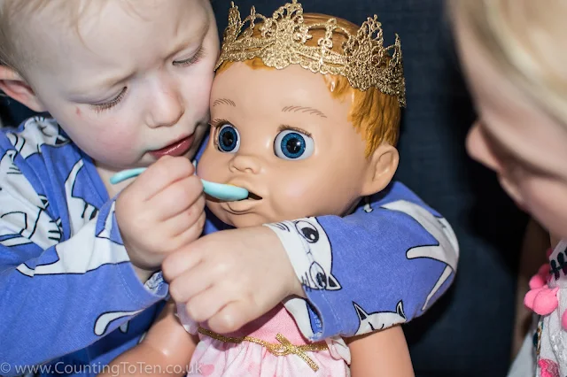 Luvabella being spoon fed by a toddler