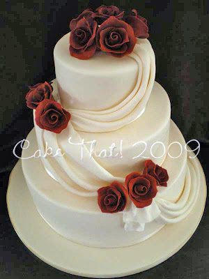 A classic three tier cake with Burgundy sugar roses