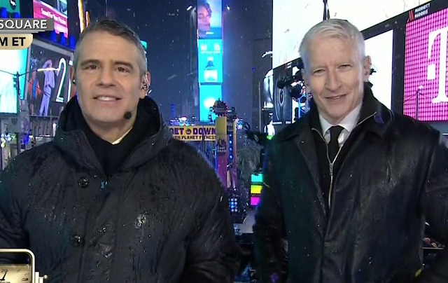 Drenched CNN hosts blast NYPD for banning them from having UMBRELLAS in Times Square security clampdown, as rain soaks Ball Drop and even grounds specially-commissioned police drone