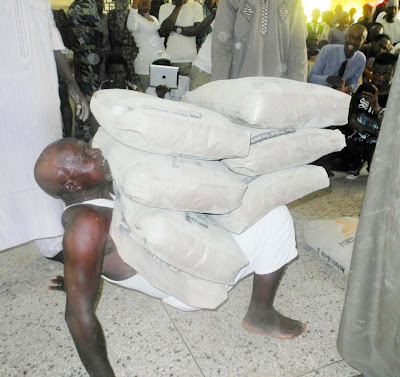 Abdullahi Kurma carrying 6 bags of cement