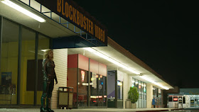 woman standing outside a blockbuster video