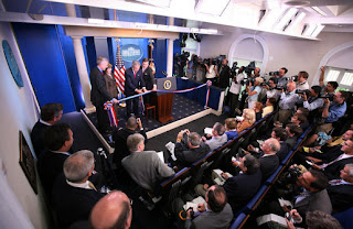 President George W. Bush and Mrs. Laura Bush participate in the ribbon-cutting ceremony to officially open the newly renovated James S. Brady Press Briefing Room Wednesday morning, July 11, 2007, at the White House. White House photo by Eric Draper.