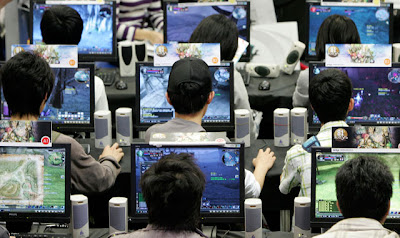 gamers playing video games at an internet cafe