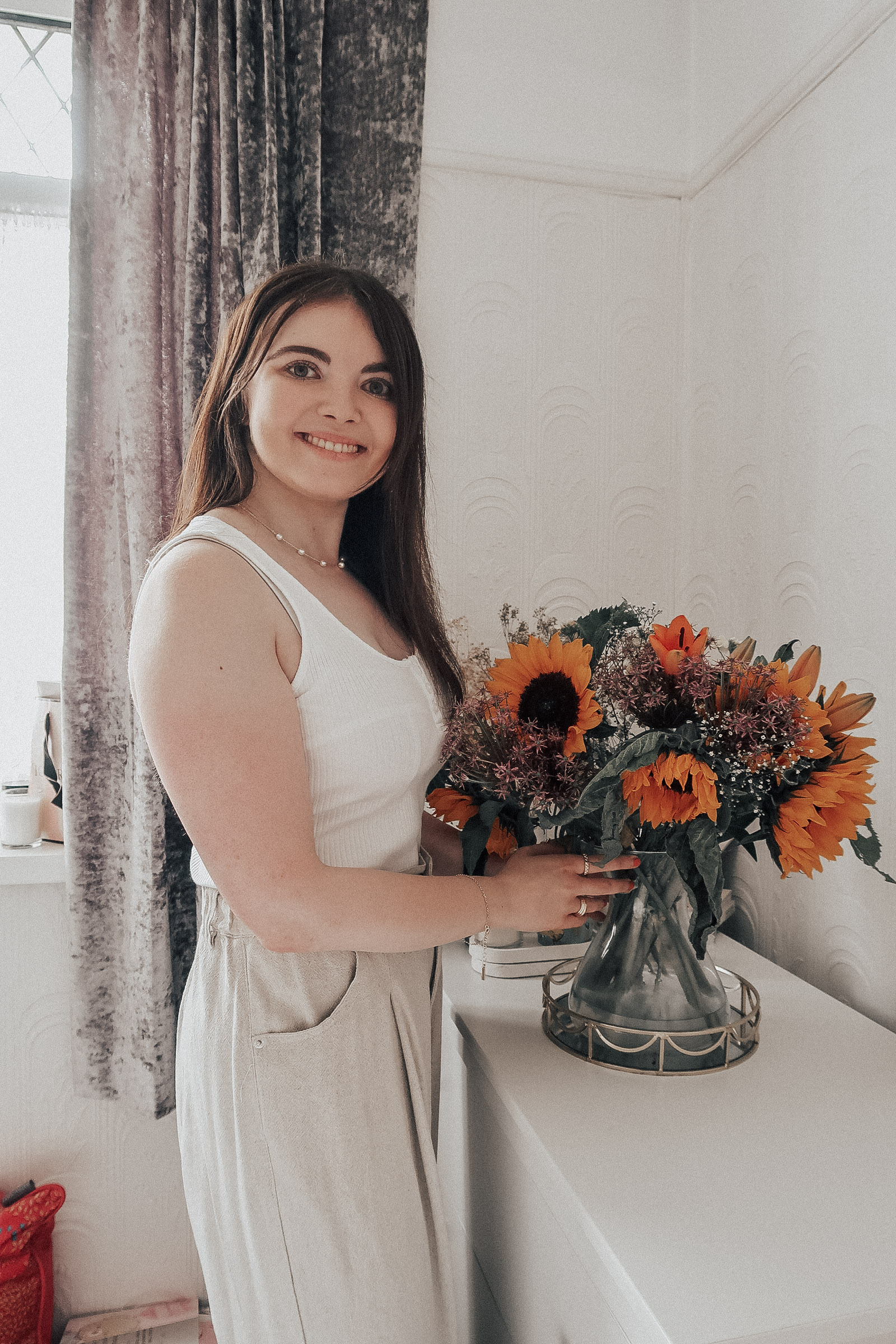 A woman with a bunch of Haute Florist flowers
