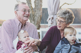 Photo of grandparents holding their grandchildren.