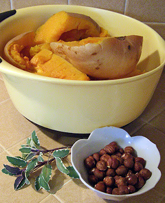 Bowl of roasted butternut, sage leaves, and hazelnuts