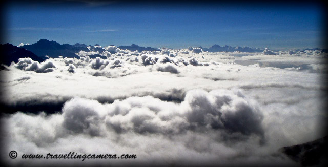 What all we see after reaching Shrikhand Mhadev @ 19000 feets: Posted by VJ @ Travellingcamera.com Its been two years when I have experienced all these things and  still I remember  most of the things very clearly. It was really an amazing experience for me and probably the best ...Here are few more photographs of Shrikhand Mahadev...Last day trek gives extremely different experince on snow covered hills with low oxygen level... I was not able to enjoy this beauty while crossing this area... Sometimes low oxygen makes you unconscious..After reaching near Shivlingam, there is only snow and huge rocks around the place. Hard to find out grass, flowers, plants on these hills...There is heavy cloud movement  around these hills and sometimes  we  had to slow down our movement because of visibility issues...Beautiful view of mountains and clouds on trek to Shrikhand MahadevClouds, and sunlight over a mountain on trek to Shrikhand MahadevI say it Cloud Store @ Shrikhand Mahadev :)I say it Cloud Store @ Shrikhand Mahadev :) It was a huge area between hundreds of mountains and we found it completely filled with these clouds in early morning... When we came back, there was no differences and we started guessing about the area below these clouds...Shrikhand Mahadev is one of the adobes of Lord Shiva. People worship the natural, rock-made shiva-lingam which is approx 72 feet high. The view is breathtaking form the top. There are 2 ways to reach to the top, one is from Neermand and another from Arsu side: and we took first one. The trek from jaon Village takes approximately 38 kms one side to reach Shrikhand Peak.Srikhand Mahadev peak, located at an altitude of 5200 meters resembles the Shivling. It is said that Lord Shiva meditated here and the Pandavas used to visit this peak. Devotees of Lord Shiva visit at the top of the mountain where there is a small shrine of Lord Shiva. Devotees trek to the peak during the main pilgrimage season of July and August.I recommend you to carry plenty of water, energy bars, Glucose, walking stick and torch with you. These things make your trek quite comfortable... Don't forget some basic medicines by consulting your doctor by describing about this trek :) I found ist most difficult to climb huge rocks in our final strech to Shrikhand Mahadev...It is believed there are total seven Kailash mountains. The well known Mansarovar Kailash in Tibet, Adi Kailash in Pithoragarh district of Uttrakhand, Amarnath Kailash in J&K, Kinner Kailash in Kinnaur district of Himachal Pradesh, Mani Mahesh Kailash in Chamba District of Himachal Pradesh,Sri Khand Kailash in Shimla district of Himachal Pradesh. Seventh one is believed to be Boorha Kailash and is yet to be located. A Lovely flower on the way to Shrikhand Mahadev...