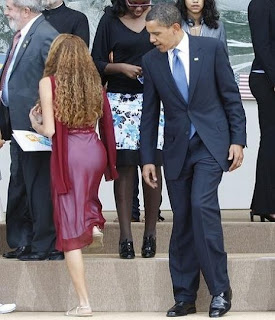 A misleading picture that shows U.S. President Barack Obama admiring Brazilian junior G8 delegate Mayora Tavares butt