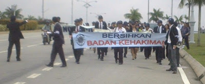 banner bearers leading the Long March for Justice