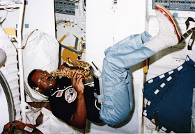 Ronald McNair playing saxophone in space