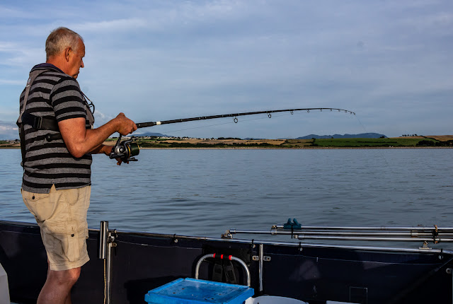 Photo of Phil fishing from Ravensdale's aft deck