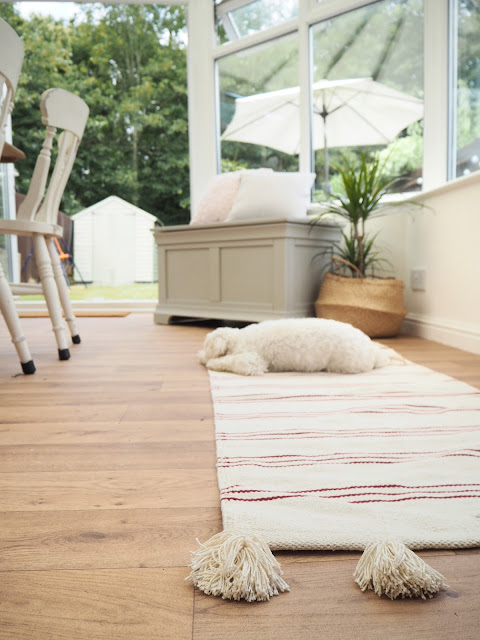 Turn an old unused conservatory into a stylish sunroom with dining table and chairs and blanket box seating area from The Cotswold Company