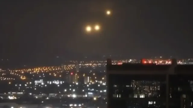 Amazing UFO sighting over O'ahu in Hawaii USA saw three UFO Orbs in orange over city centre.