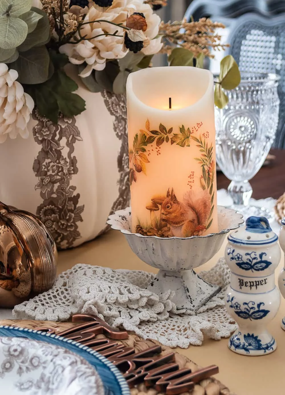 pumpkin centerpiece, faux florals, squirrel candle, blue and brown transferware dishes