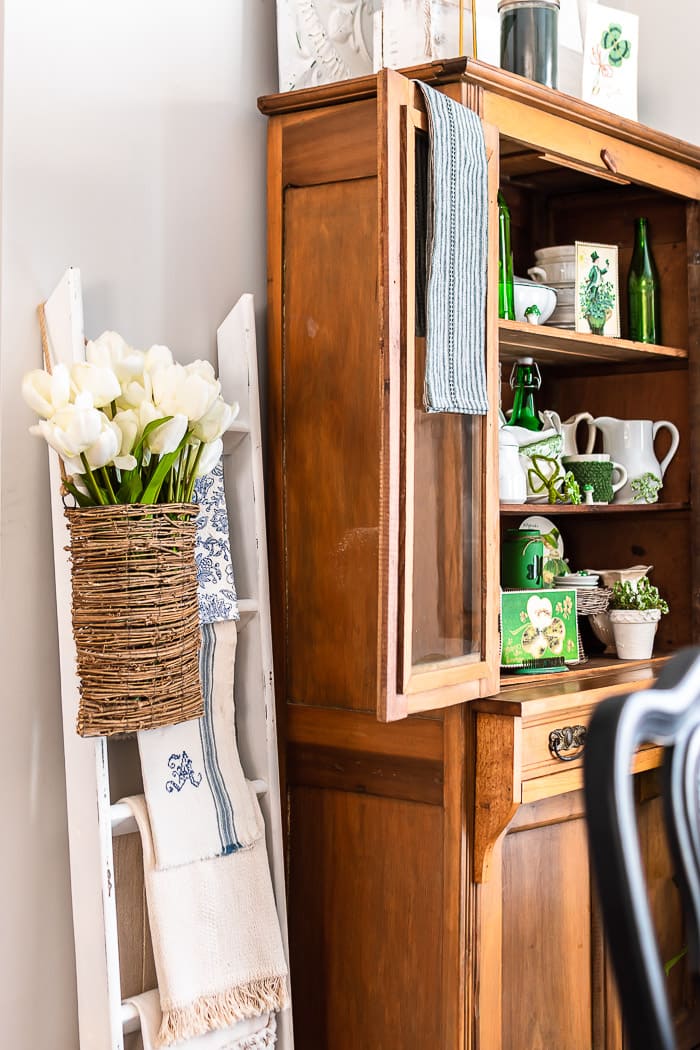 pine cabinet, white ladder, basket with tulips