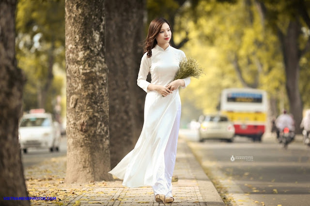 Vietnamese teen girl walking on the street with white ao dai 3