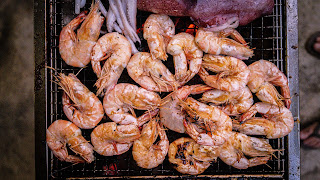 large shelled prawns on a grill