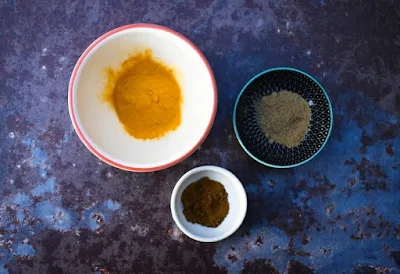 small bowls of spices, turmeric, ginger and cumin