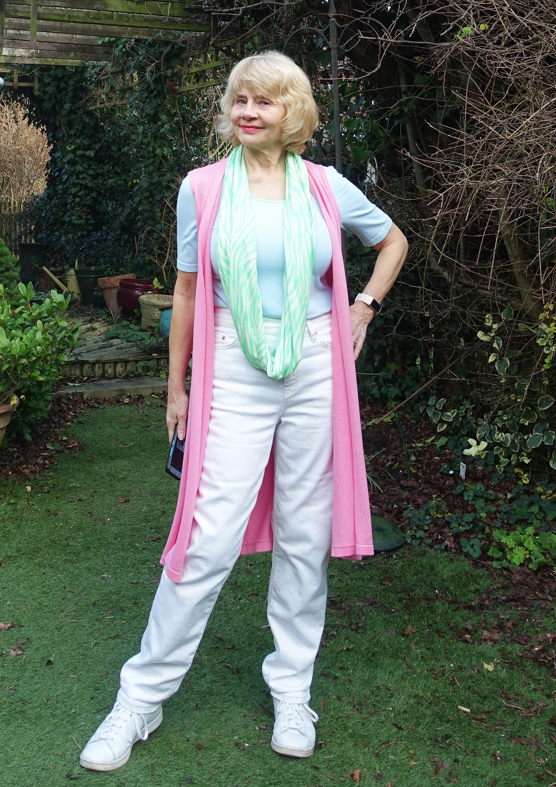 Sleeveless long rose pink cardigan worn with white jeans in December by Is This Mutton blogger Gail Hanlon