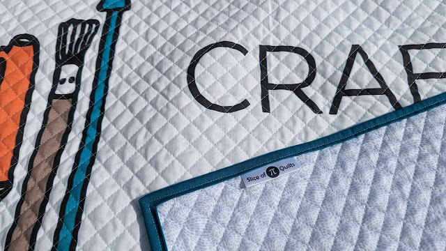 The Craft Industry Alliance logo printed on fabric and made into a quilt