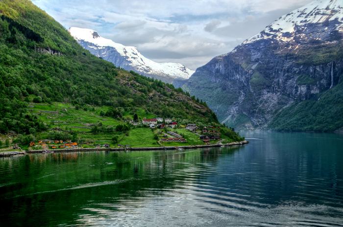 The Geirangerfjorden is a fjord in the Sunnmøre region of Møre og Romsdal county, Norway. It located entirely in Stranda Municipality. It is a 15-kilometre (9.3 mi) long branch off of the Sunnylvsfjorden, which is a branch off of the Storfjorden (Great Fjord). The small village of Geiranger is located at the end of the fjord where the Geirangelva river empties into it.