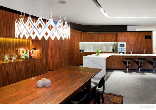 Dining room and the kitchen of River House by MCK Architects