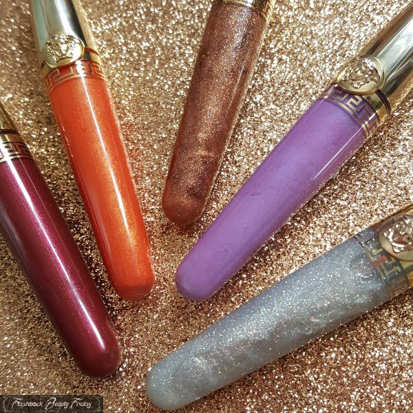 close up of glitter, metallic and pearl Versace lipglosses in clear tubes