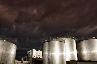 outdoor petroleum storage tanks at industrial facility