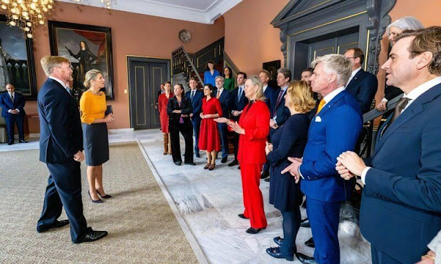 Queen Maxima wore a yellow wool and cahmere sweater by Natan and gray midi skirt by Natan. King Willem-Alexander